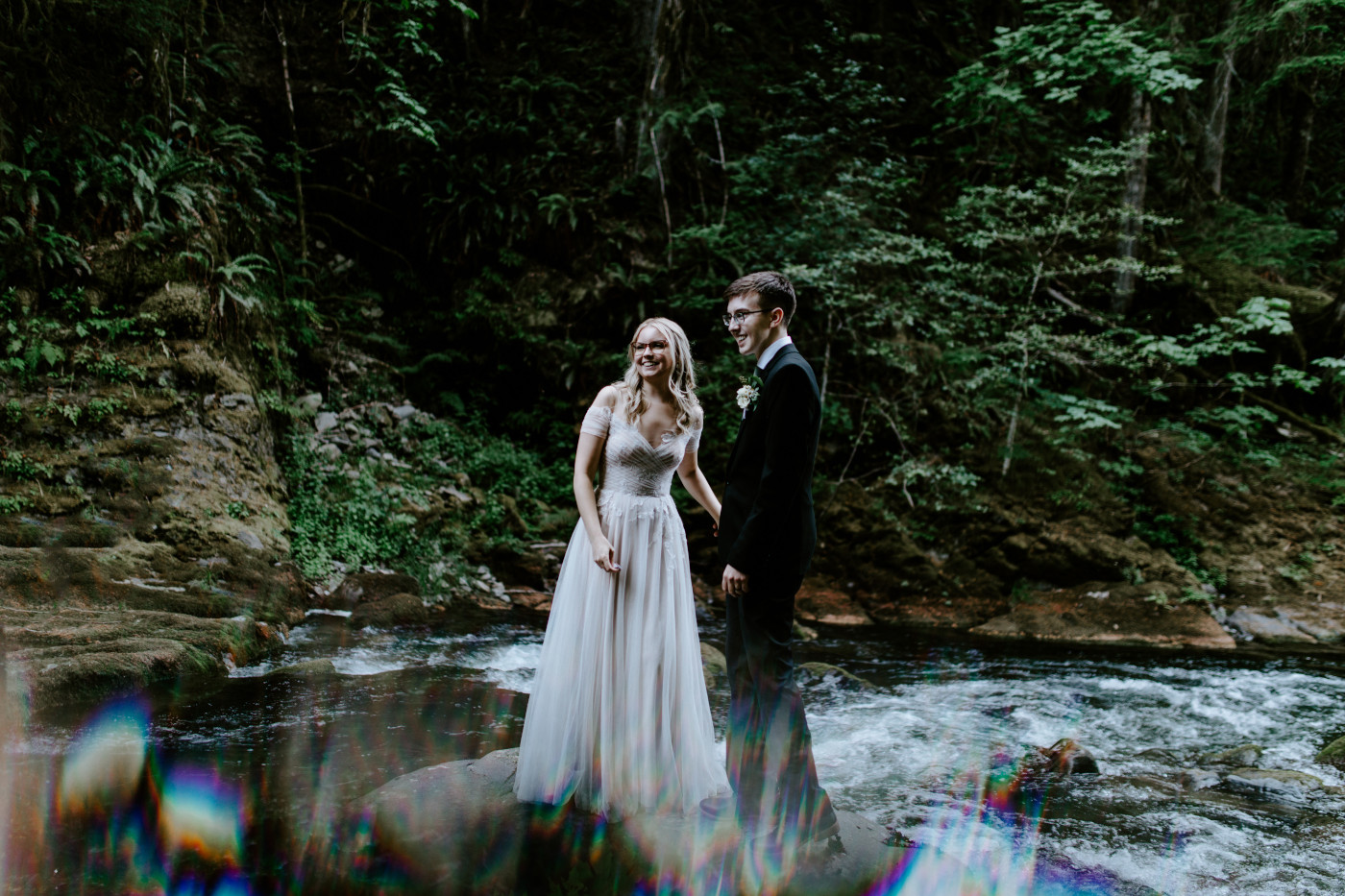 Kylie and Corey hold hands while listening to their officiant.