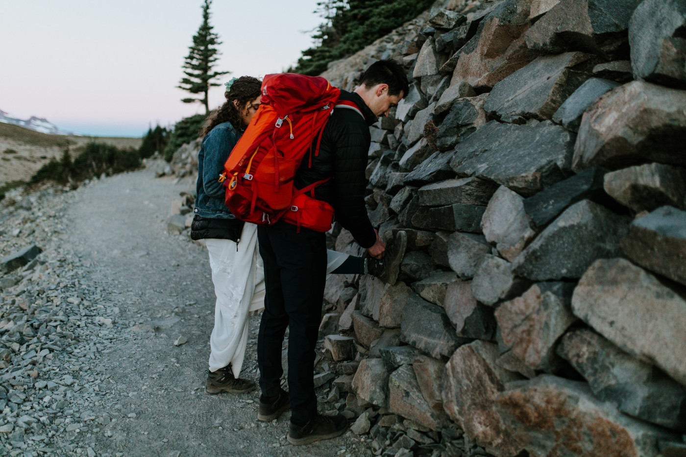 Chad ties Tasha's shoe. Elopement photography at Mount Rainier by Sienna Plus Josh.