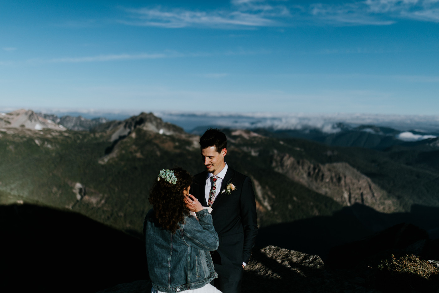 Chad listening to Tasha. Elopement photography at Mount Rainier by Sienna Plus Josh.