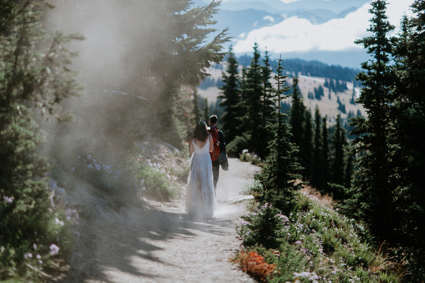 Tash and Cahd walk along a trail. Elopement photography at Mount Rainier by Sienna Plus Josh.