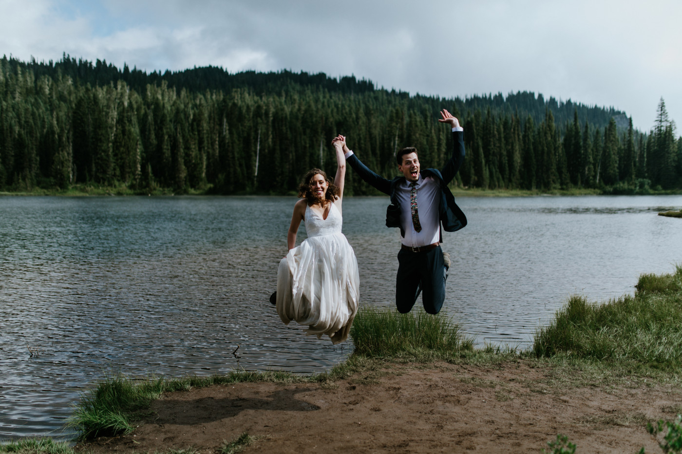 Tasha and Chad jump up. Elopement photography at Mount Rainier by Sienna Plus Josh.