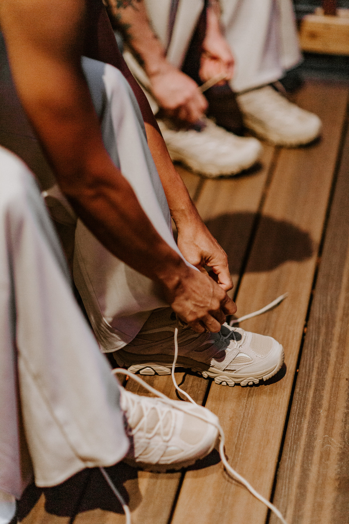 Brooks and Fred get on their shoes before their Mount Rainier Elopement in Washington.