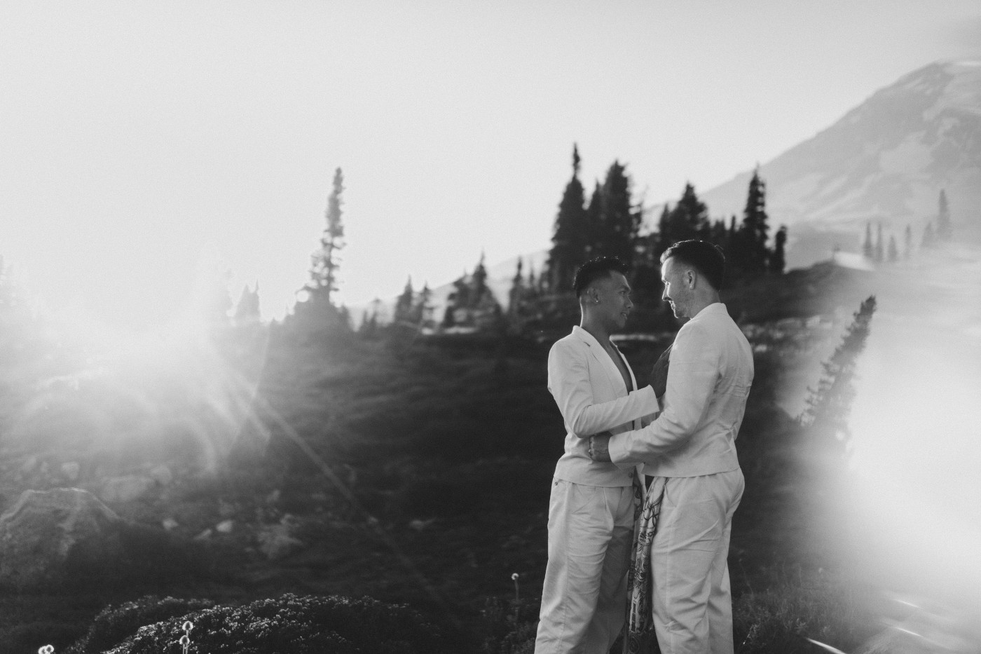 Brooks and Fred stand together in front of Mount Rainier after their elopement.