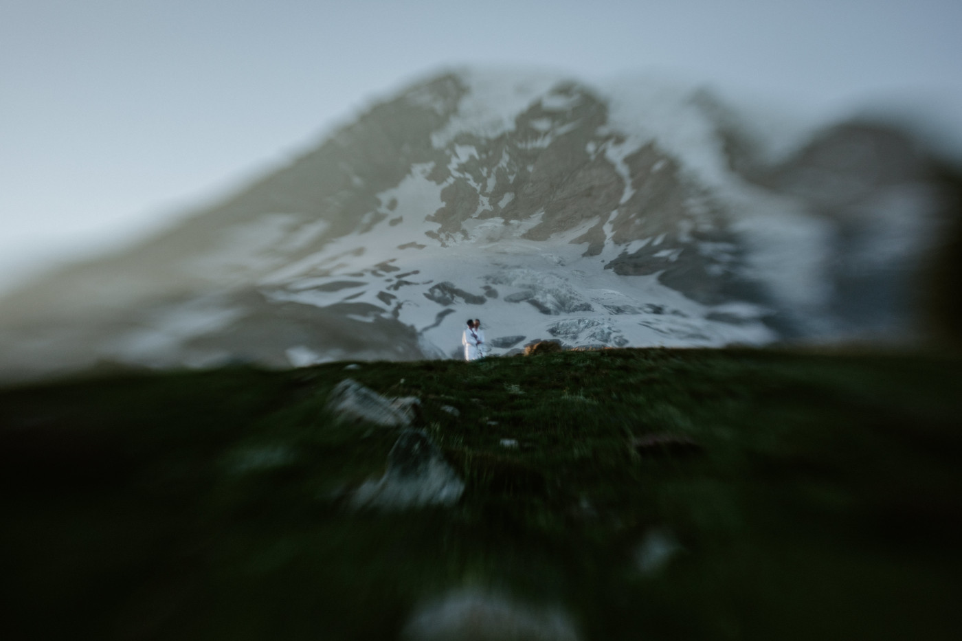 Brooks and Fred stand in front of Mount Rainier after their elopement.