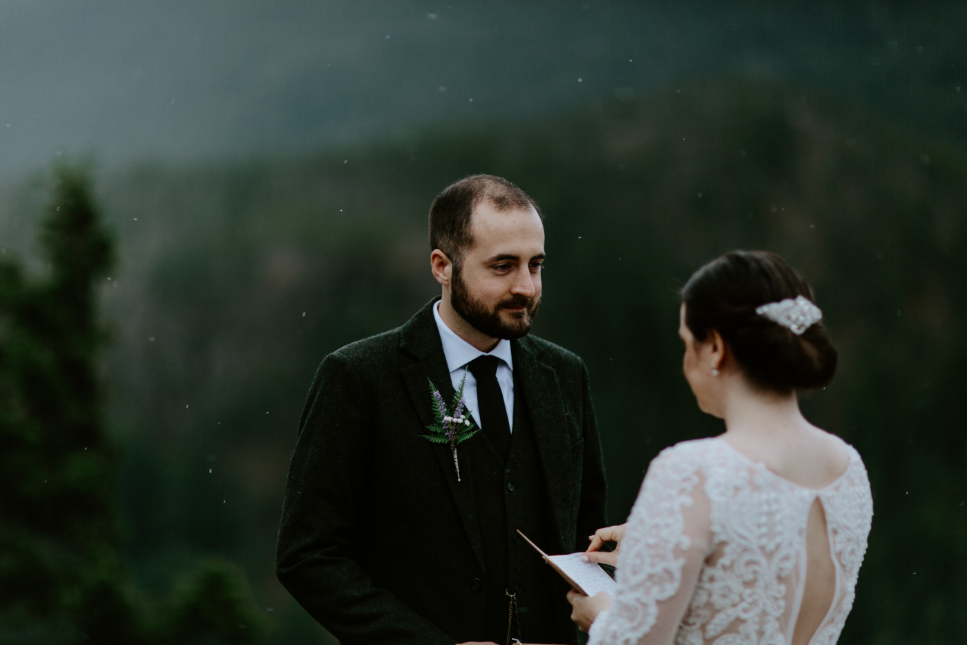 Alex listens to Elizabeth recite vows at Diablo Lake Overlook. Elopement photography at North Cascades National Park by Sienna Plus Josh.