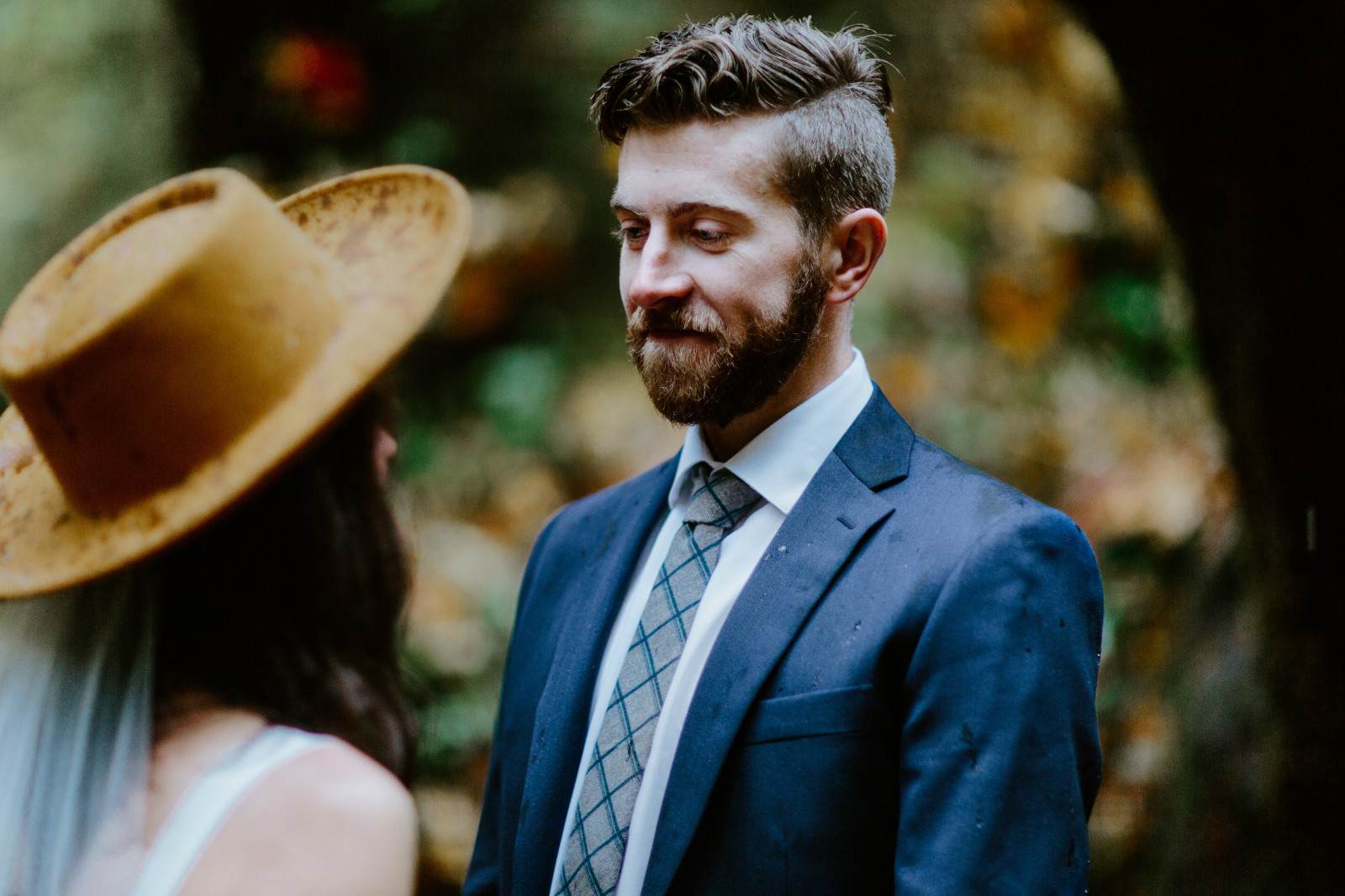 Corey admires Mollie in the rain. Elopement photography in the Olympic National Park by Sienna Plus Josh.