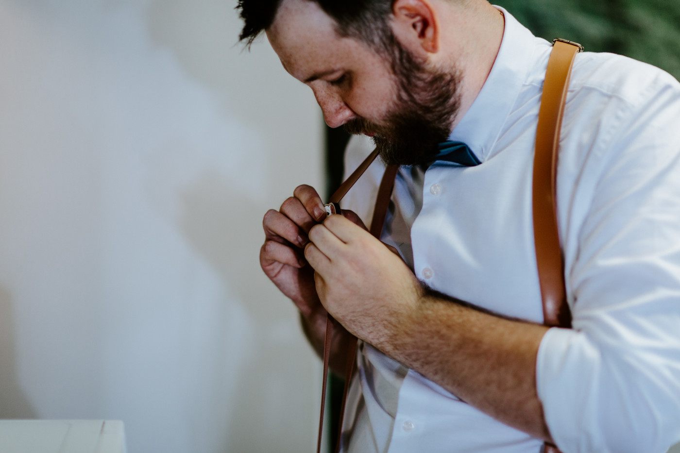 Jack puts on his special elopement day pin of his dog. Elopement photography at Olympic National Park by Sienna Plus Josh.