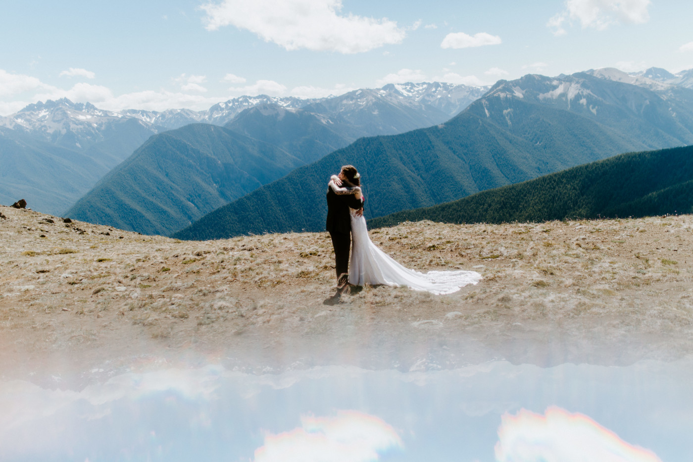 The bride and groom hug at Olympic National Park.