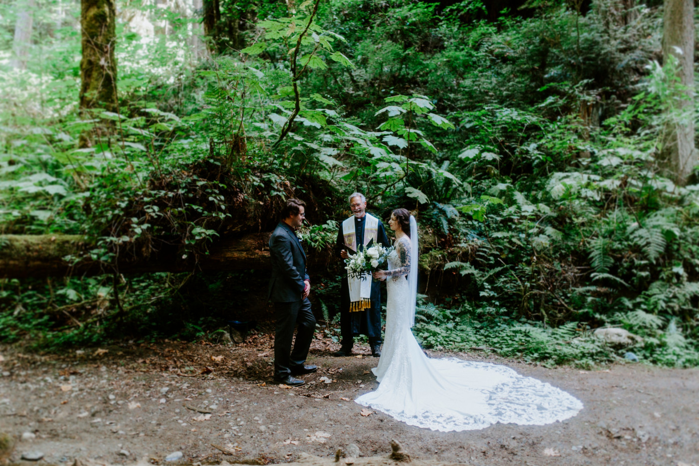 The bride and groom stand together during their elopement ceremony in Olympic National Park.