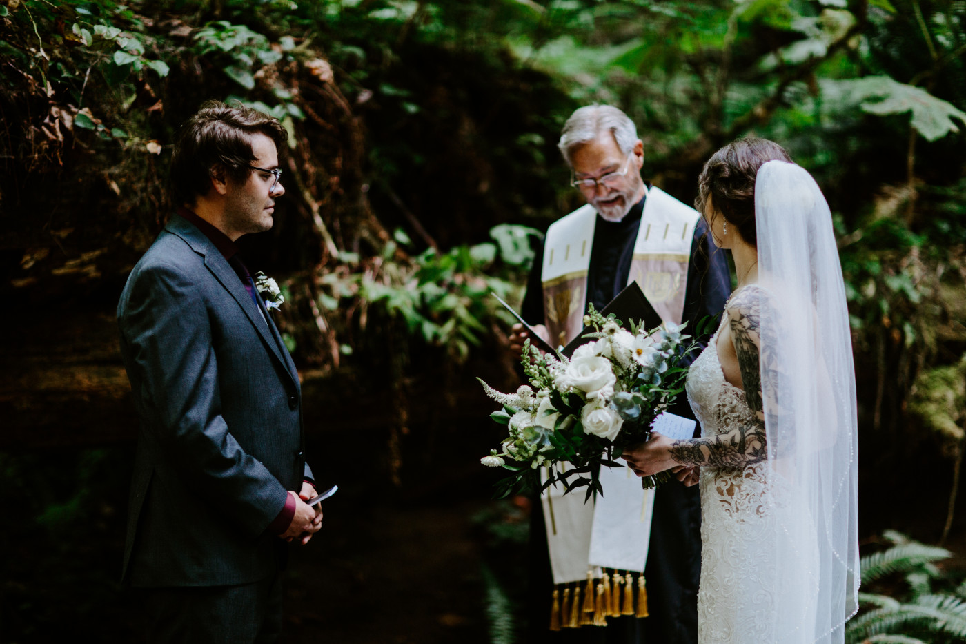 The bride and groom listen to their officiant during their elopement ceremony at Olympic National Park.