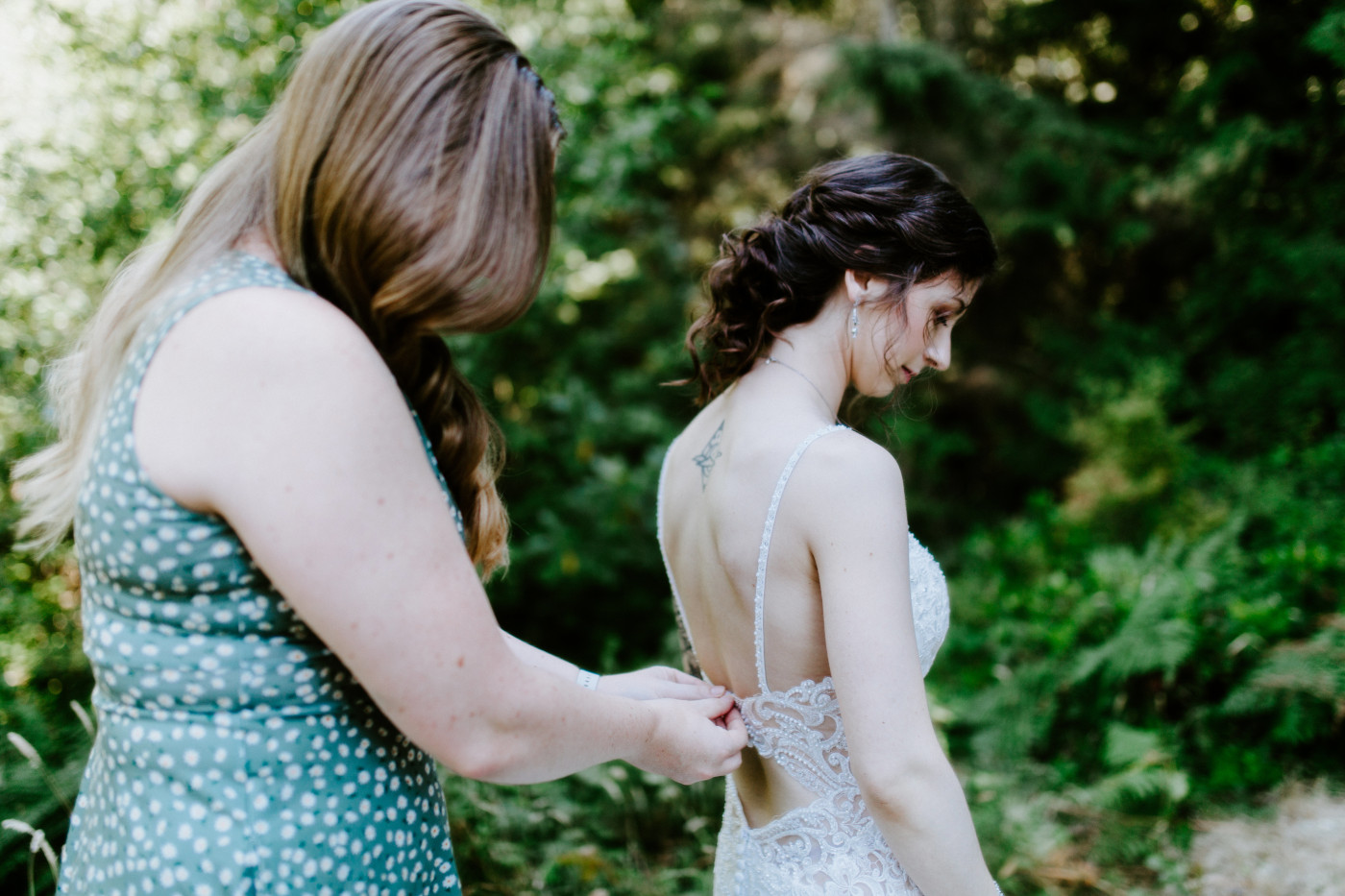 A friend helps Adrielle get ready before her elopement in Olympic Natiional Park.
