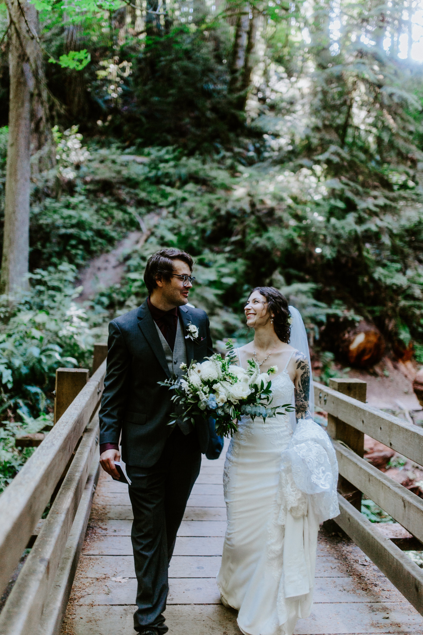 The bride and groom walk away from their wedding ceremony location in Olympic National Park.