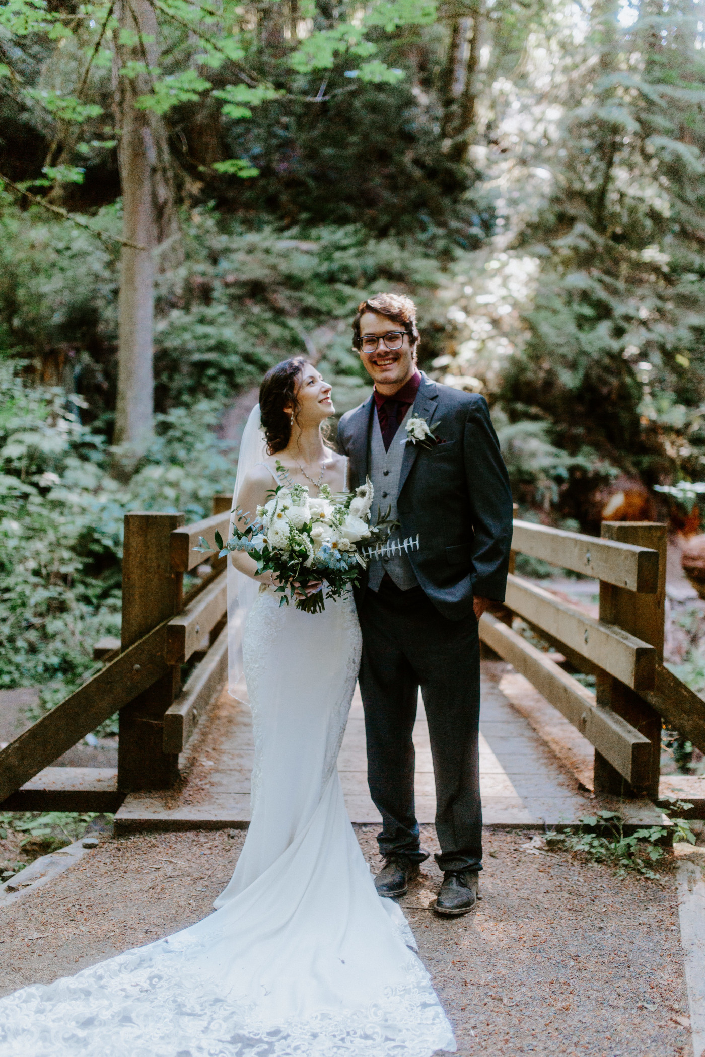 The bride and groom stand together in Olympic National Park.