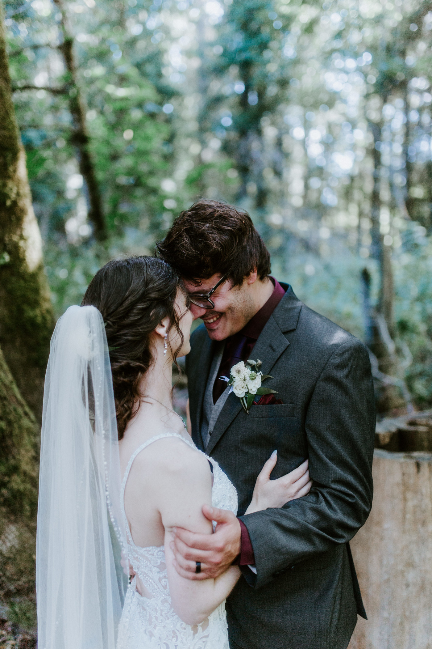 The newlyweds stand forehead to forehead in the forest after their Olympic National Park elopement.