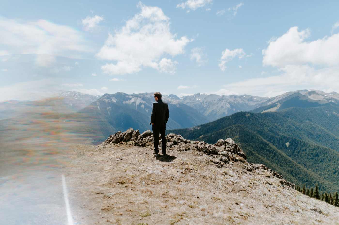 Coty stands in front of a mountain at Olympic National Park for a first look.