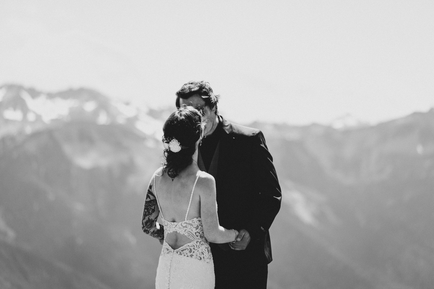 Adrielle and Coty kiss in front of a mountain at Olympic National Park.
