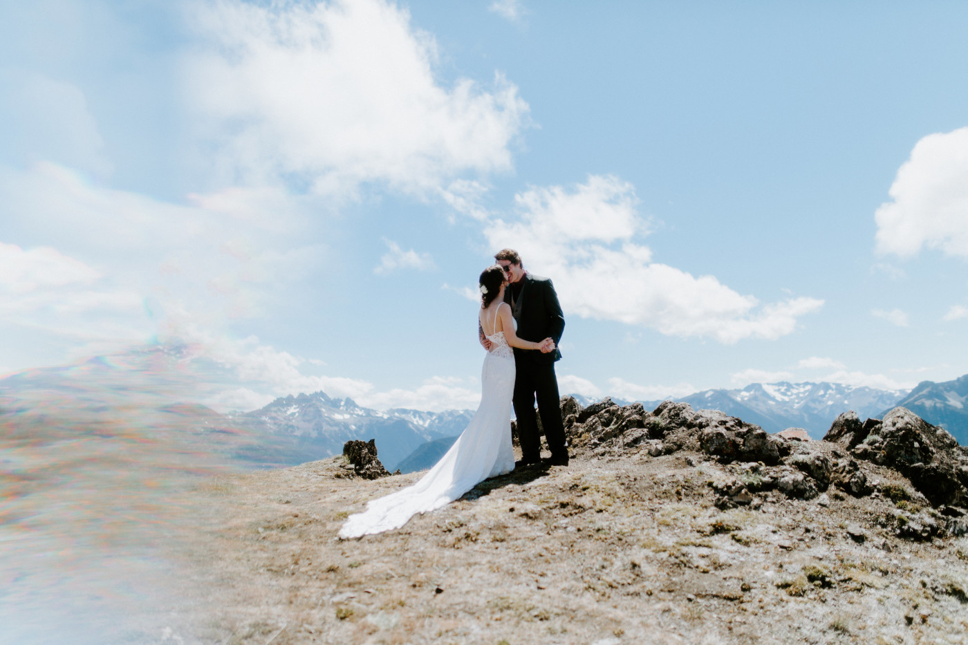 The bride and groom to be stand in front of a mountain at Olympic National Park.