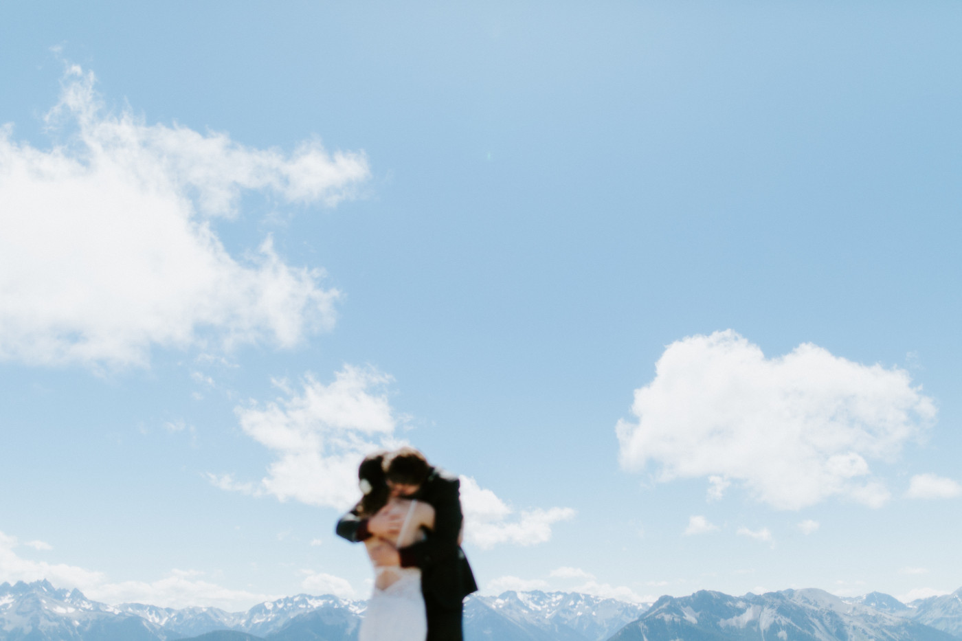 The bride and groom hug each other at Olympic National Park.