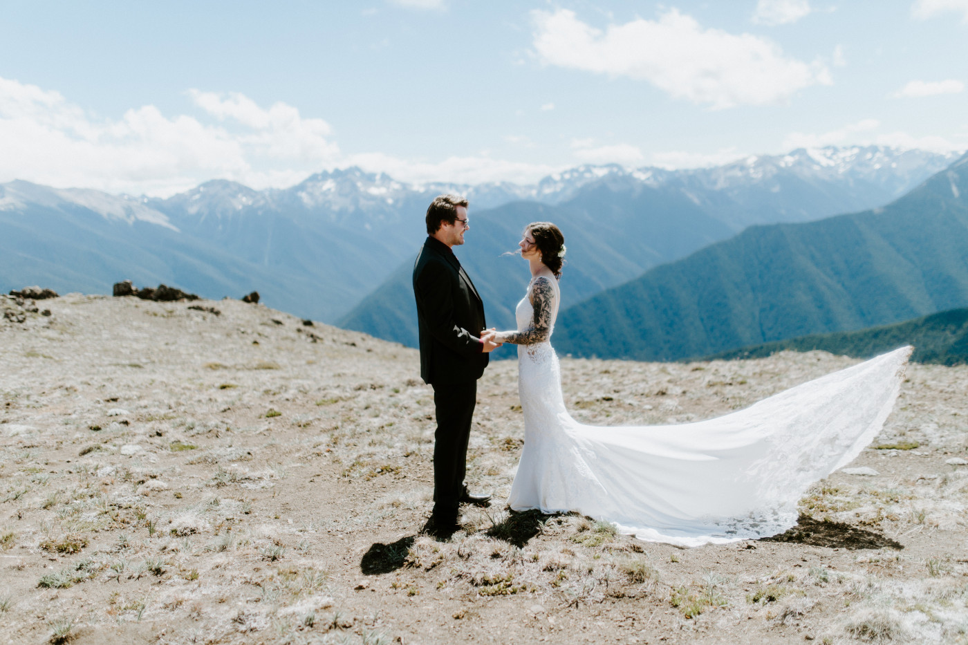 The bride and groom stand together at Olympic National Park.