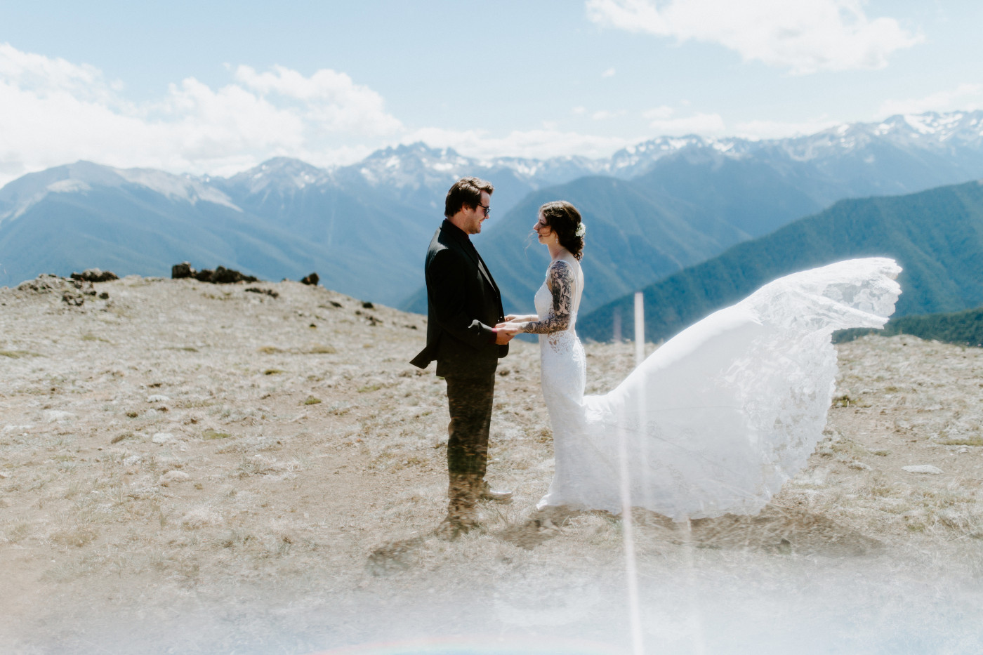 The groom and bride stand together before their elopement in Olympic National Park.