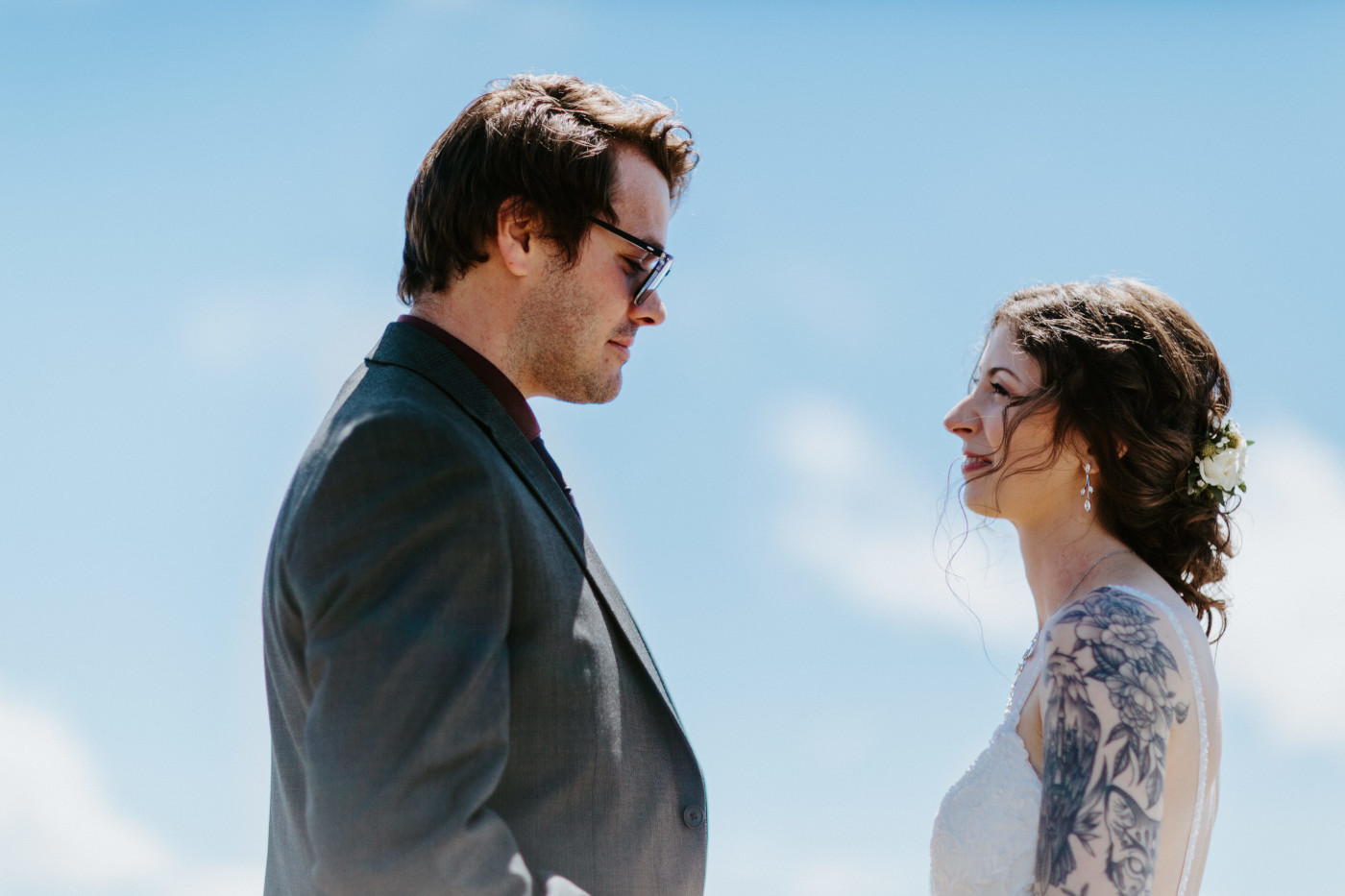 The bride and groom admire each other before their elopement at Olympic National Park.
