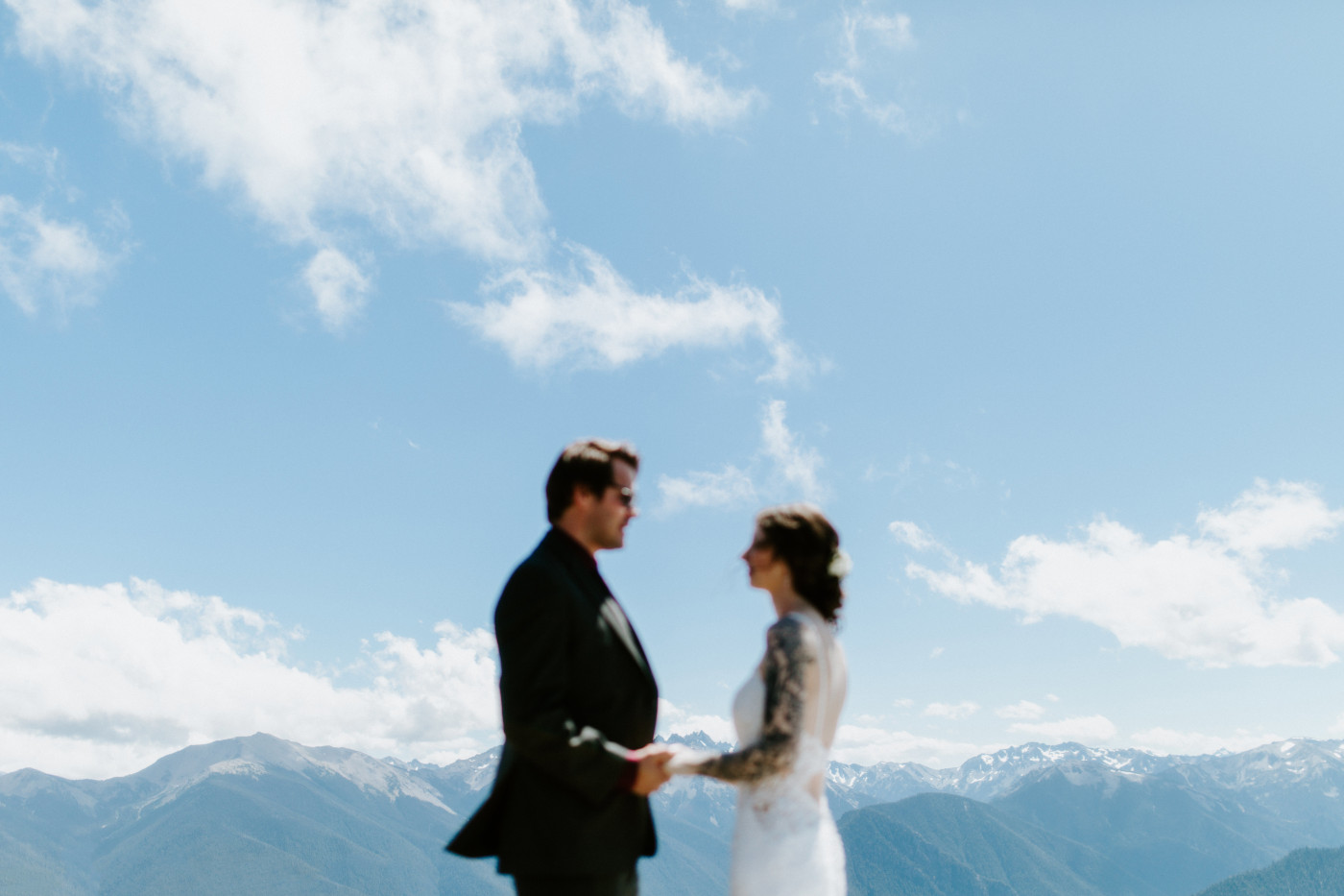 The bride and groom stand together at Olympic National Park.