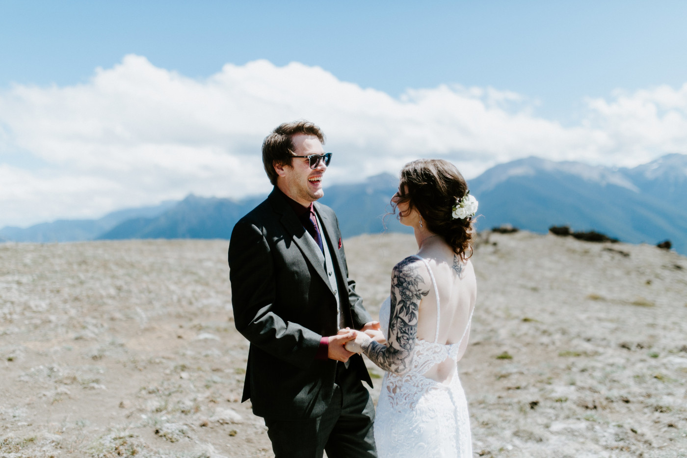 The bride and groom laugh together before their elopement in Olympic National Park.