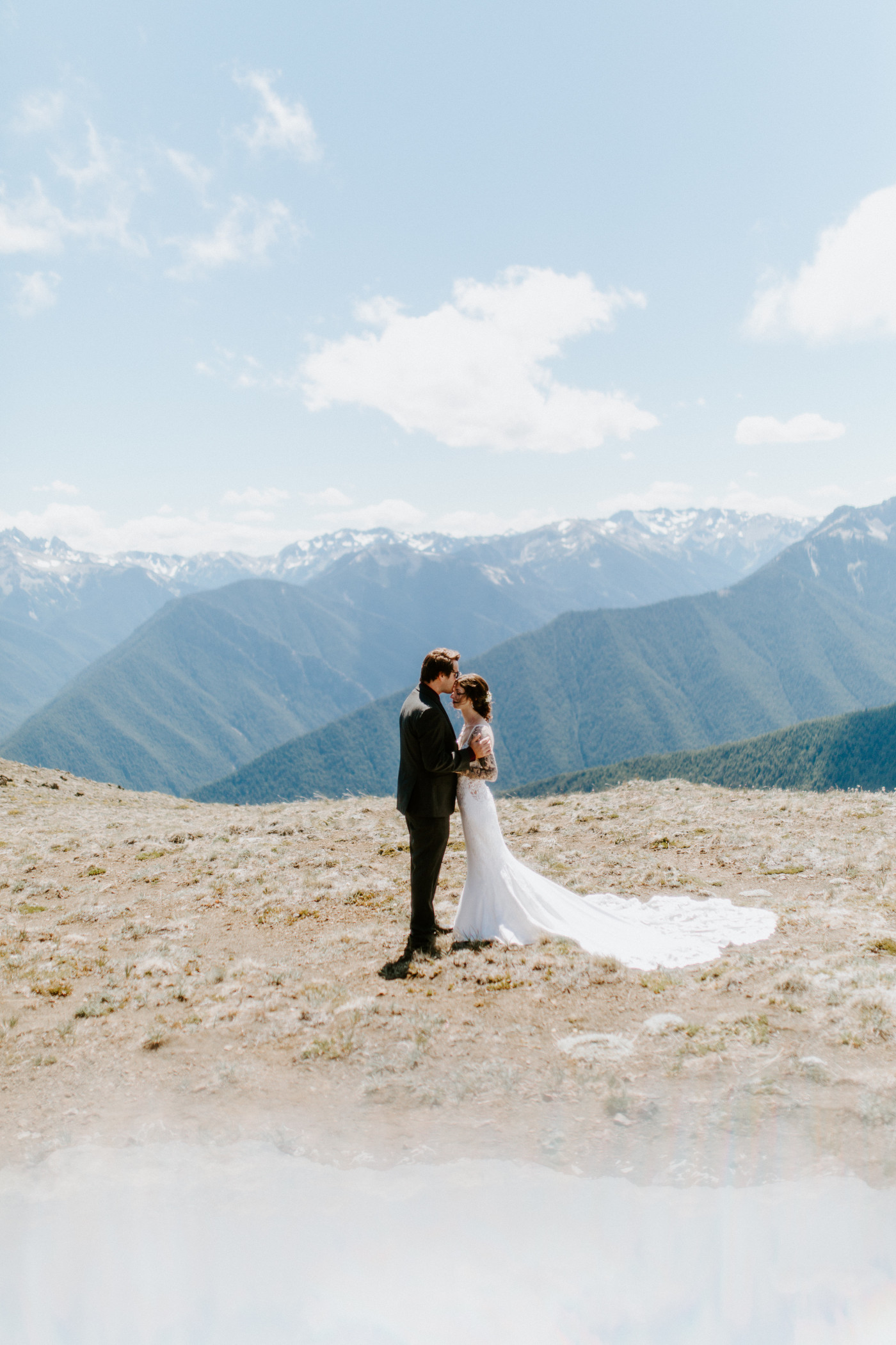 The groom kisses the forehead of his bride at Olympic National Park.