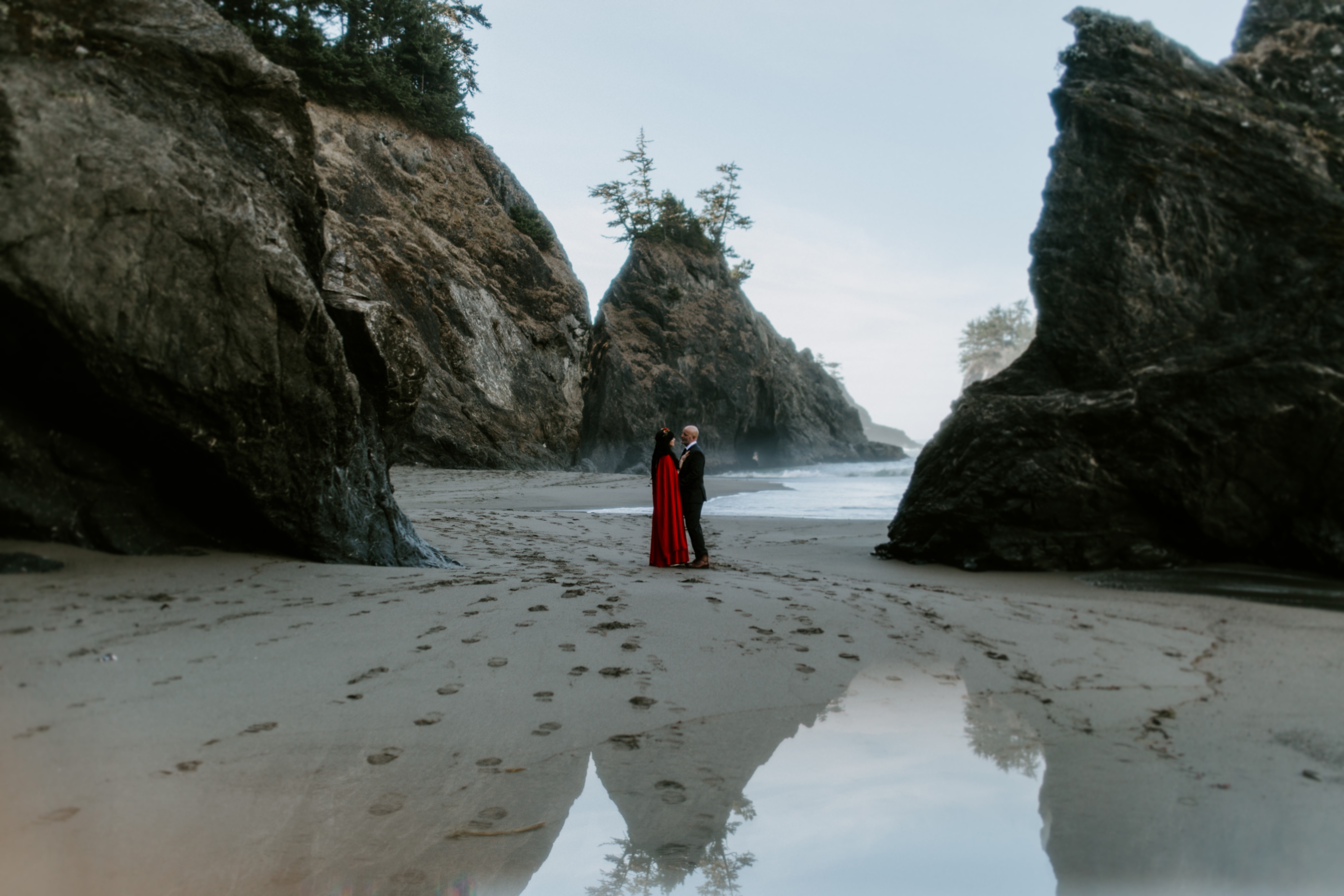 Boyd and Rachael stand together on the beach before their elopement at Samuel H. Boardman.