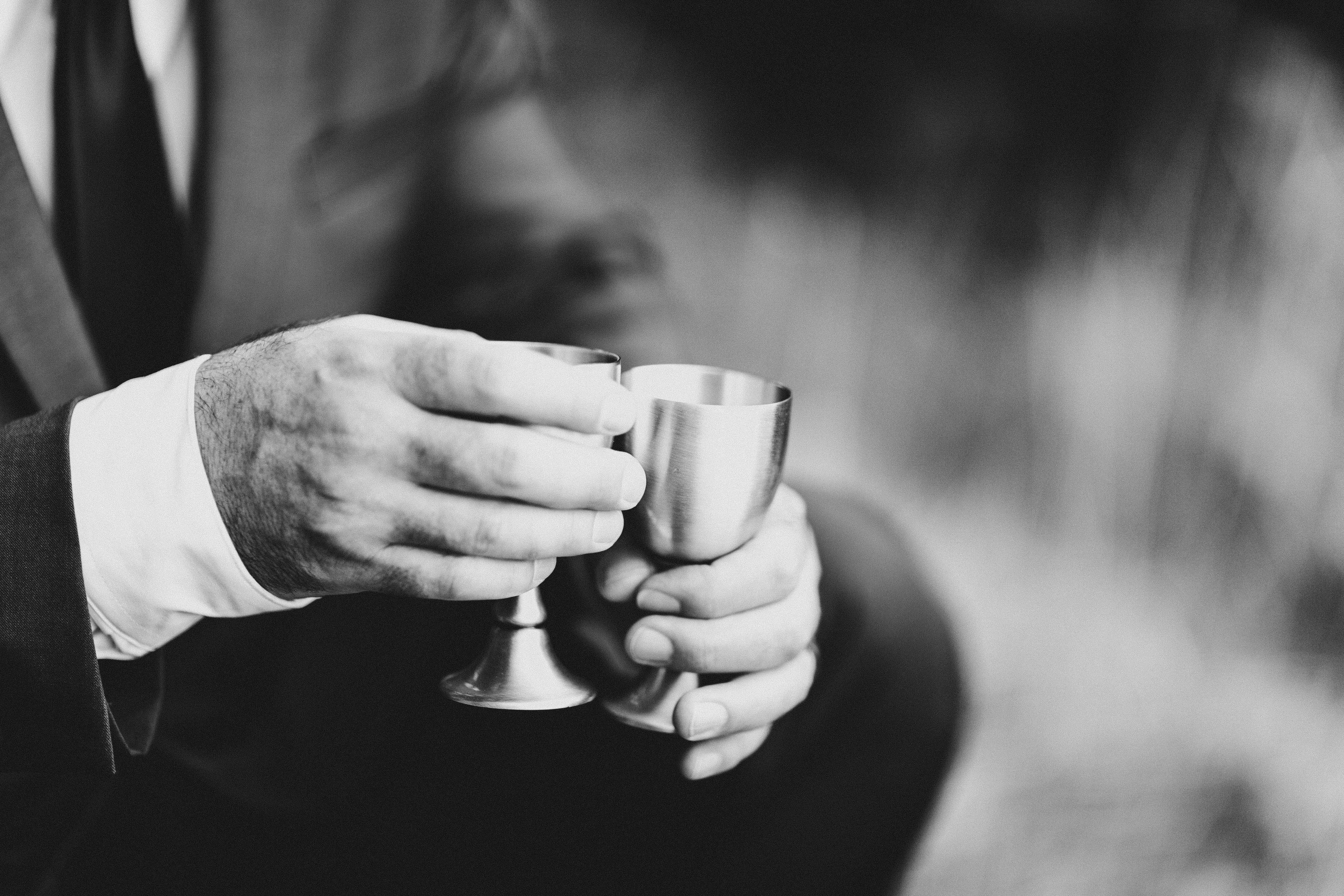Boyd holds two cups after his elopement at Samuel H. Boardman, Oregon.