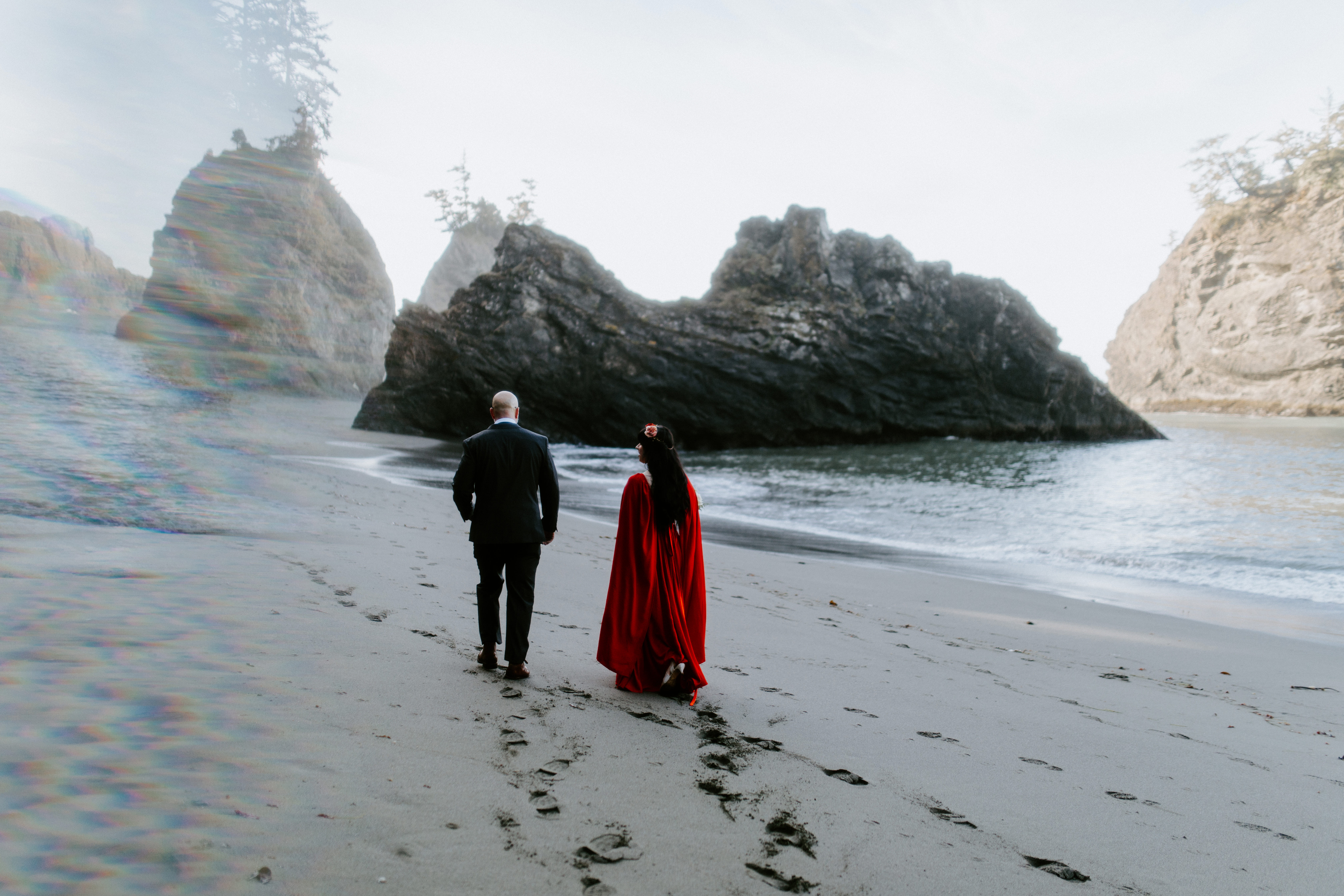 Boyd and Rachael walk together on the beach in Samuel H. Boardman, Oregon.