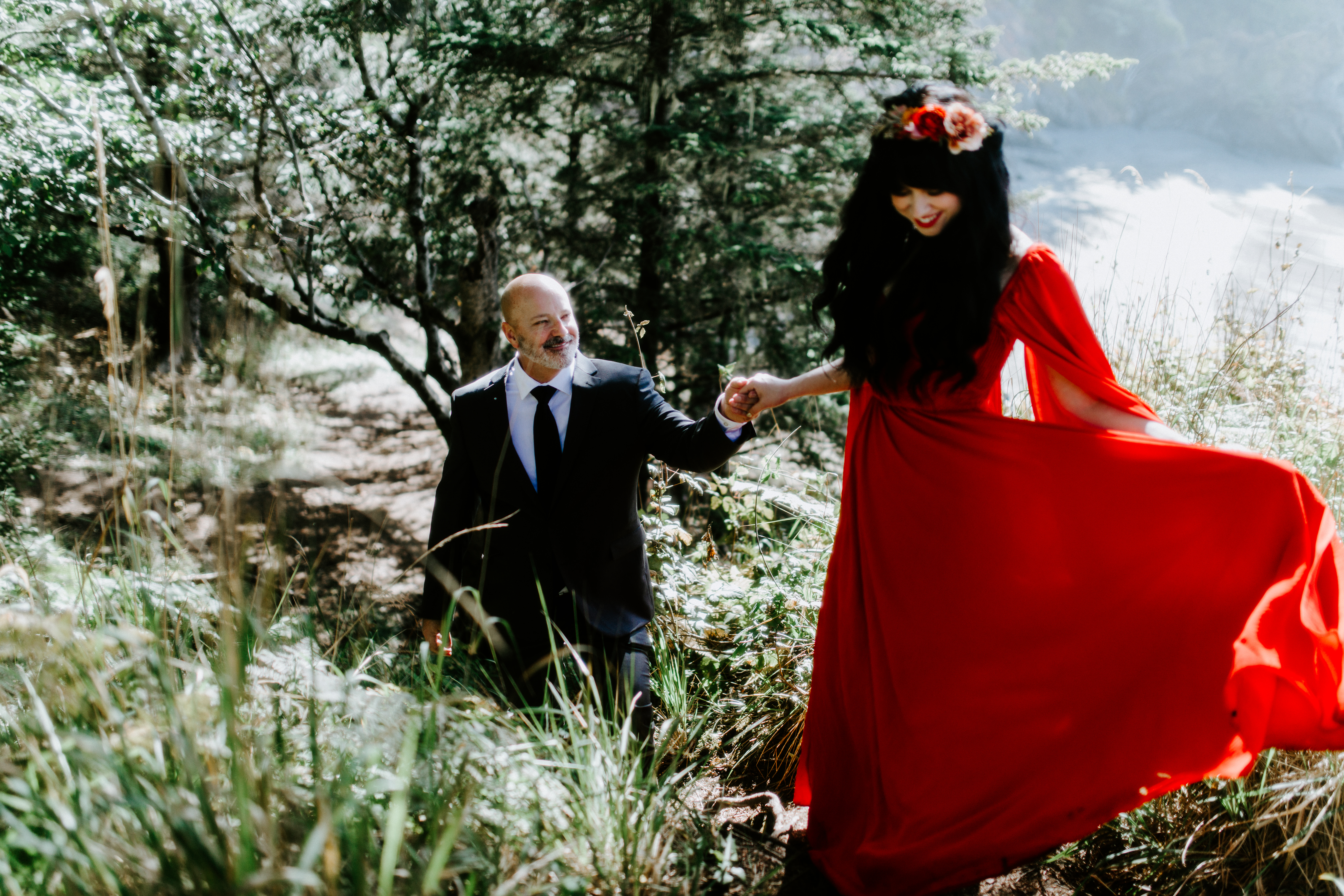 Boyd holds Rachael's hand as they walk through the forest in Samuel H. Boardman, Oregon after their elopement.