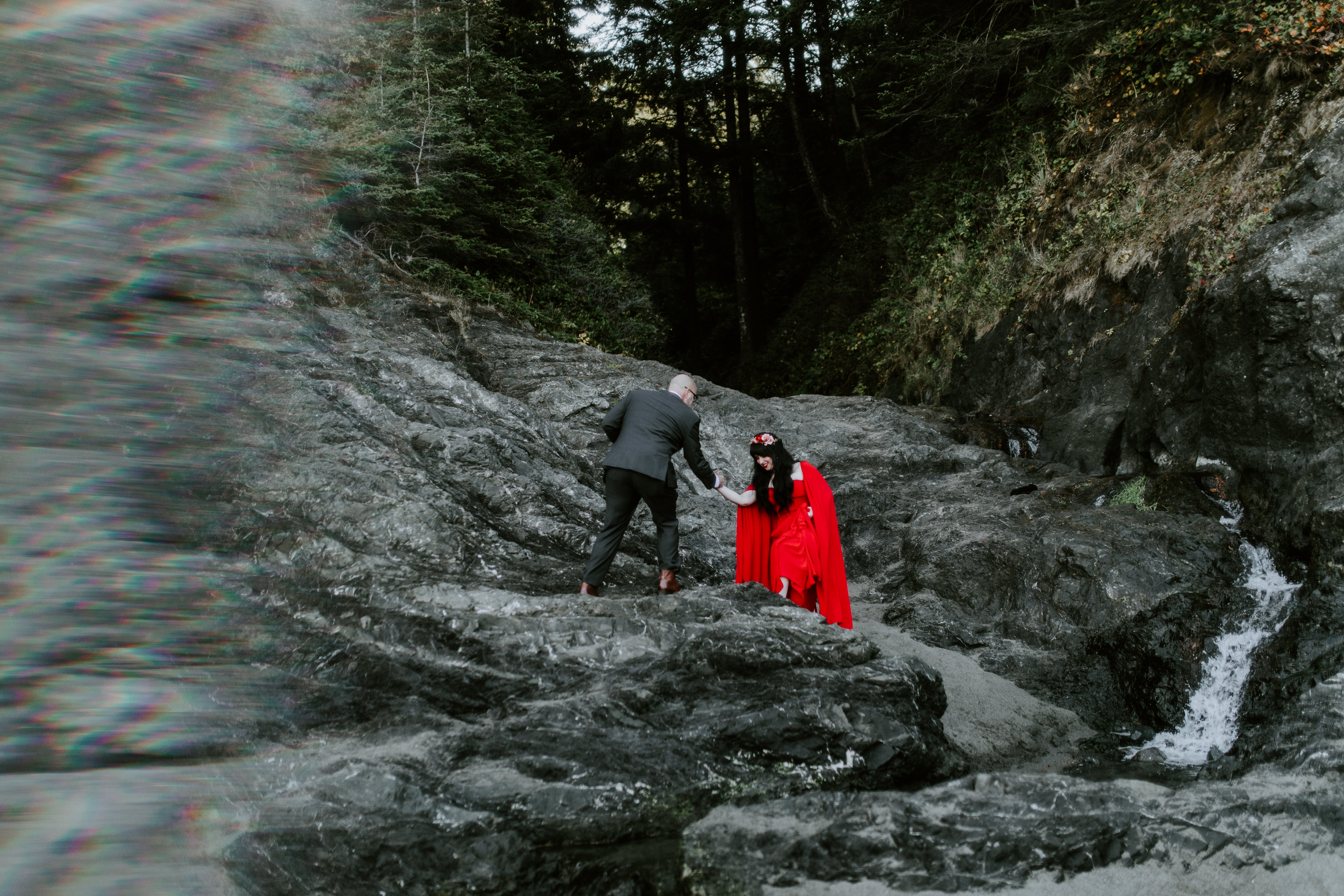 Boyd helps Rachael across the rocks at Samuel H. Boardman in Oregon.