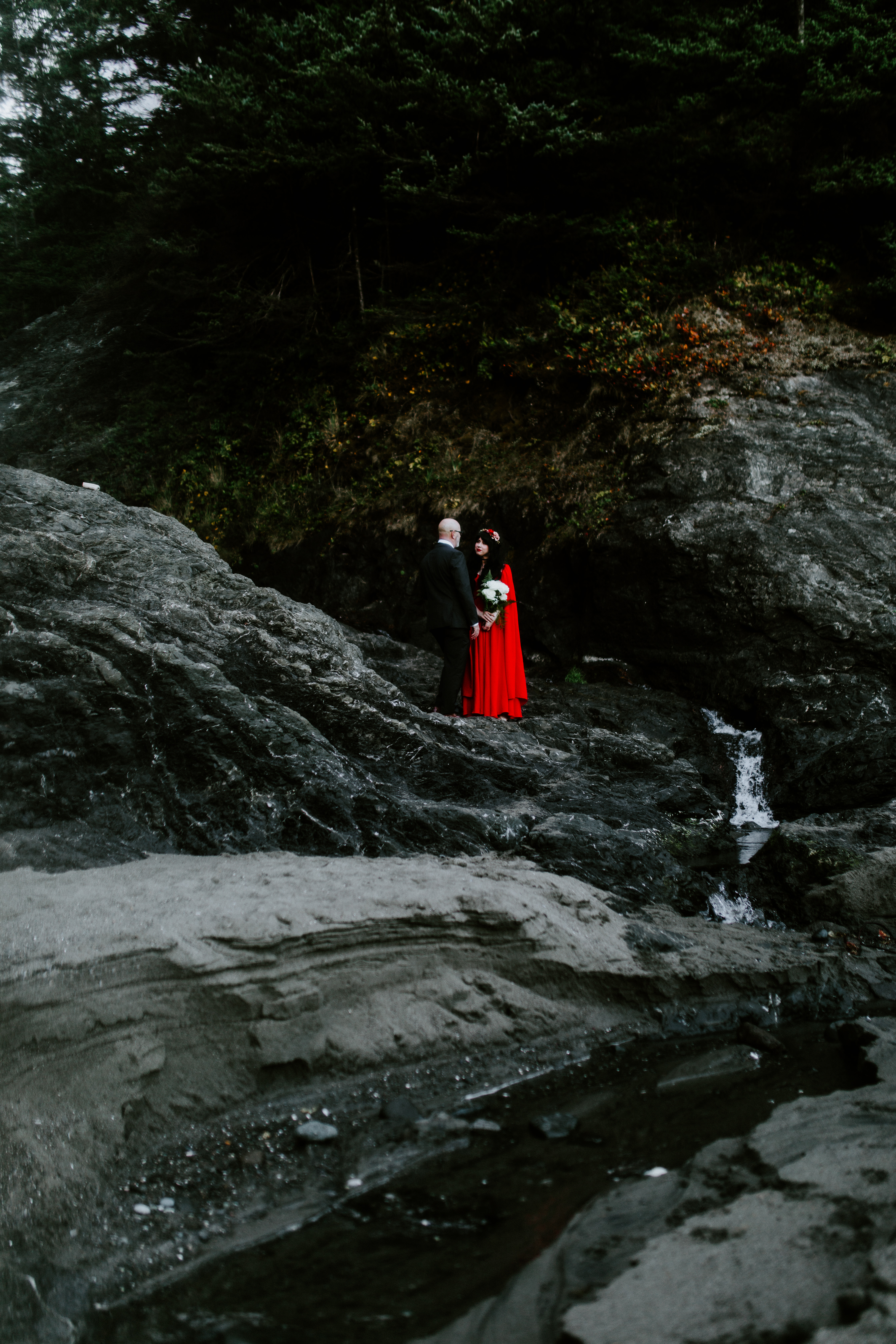 Rachael and Boyd stand together on the rocks of Samuel H. Boardman in Oregon.