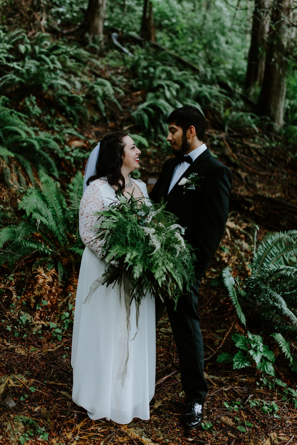 Sarah stands holding her boquet with Sam at the Skamania House in Washington. Elopement photography in Portland Oregon by Sienna Plus Josh.