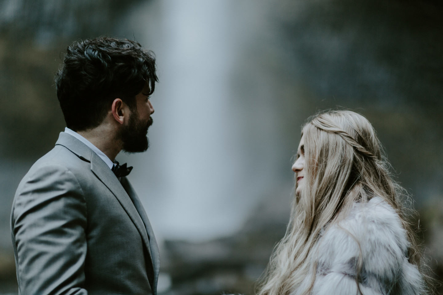 Tyanna and Boris stand in front of Latourell Falls, OR. Adventure elopement in the Columbia River Gorge by Sienna Plus Josh.