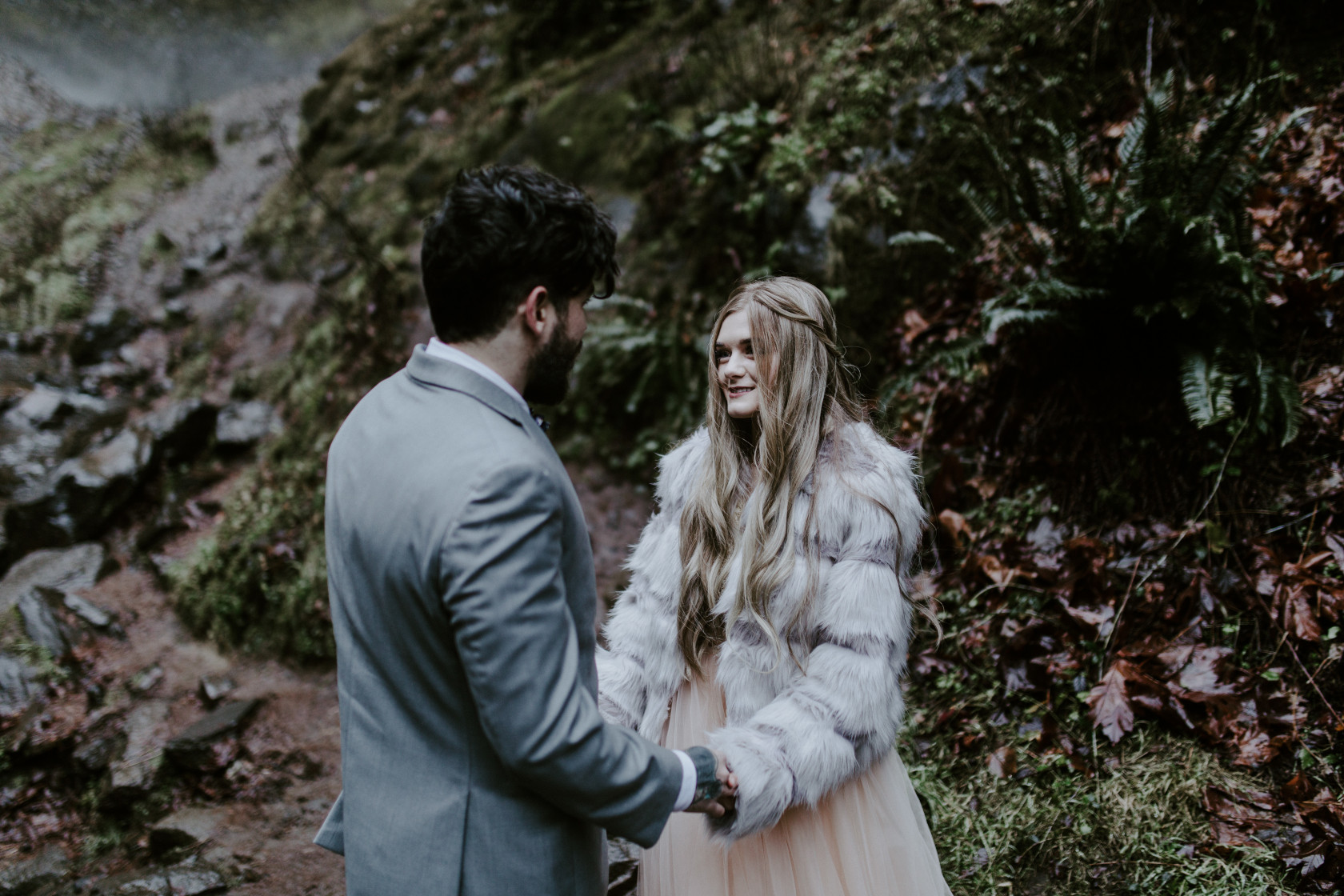 Tyanna and Boris stand in front of Latourell Falls, OR. Adventure elopement in the Columbia River Gorge by Sienna Plus Josh.