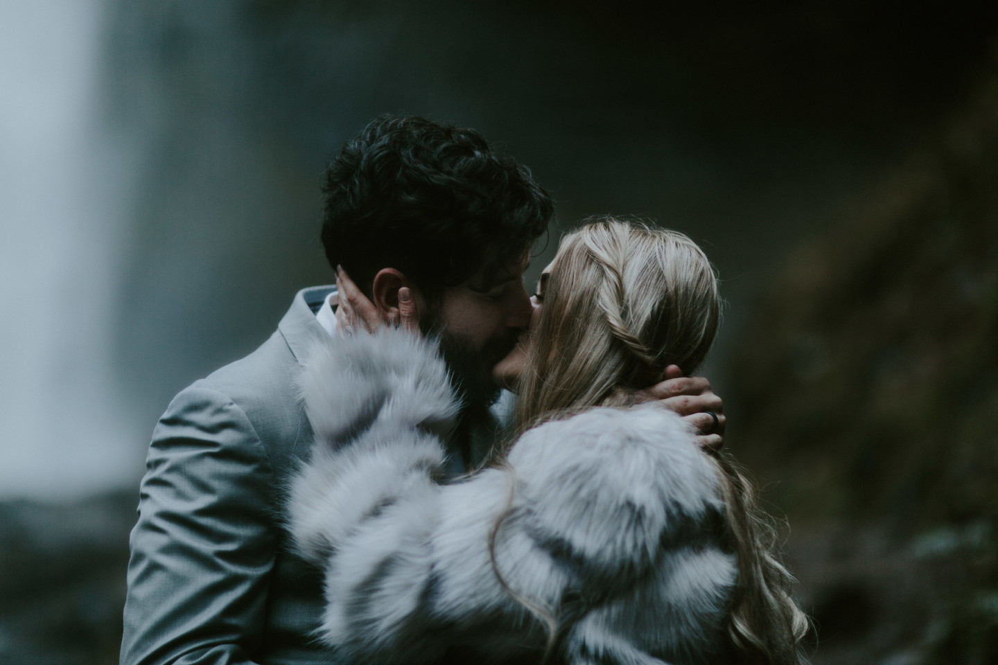 Tyanna and Boris kiss during their elopement ceremony in Latourell Falls, OR. Adventure elopement in the Columbia River Gorge by Sienna Plus Josh.