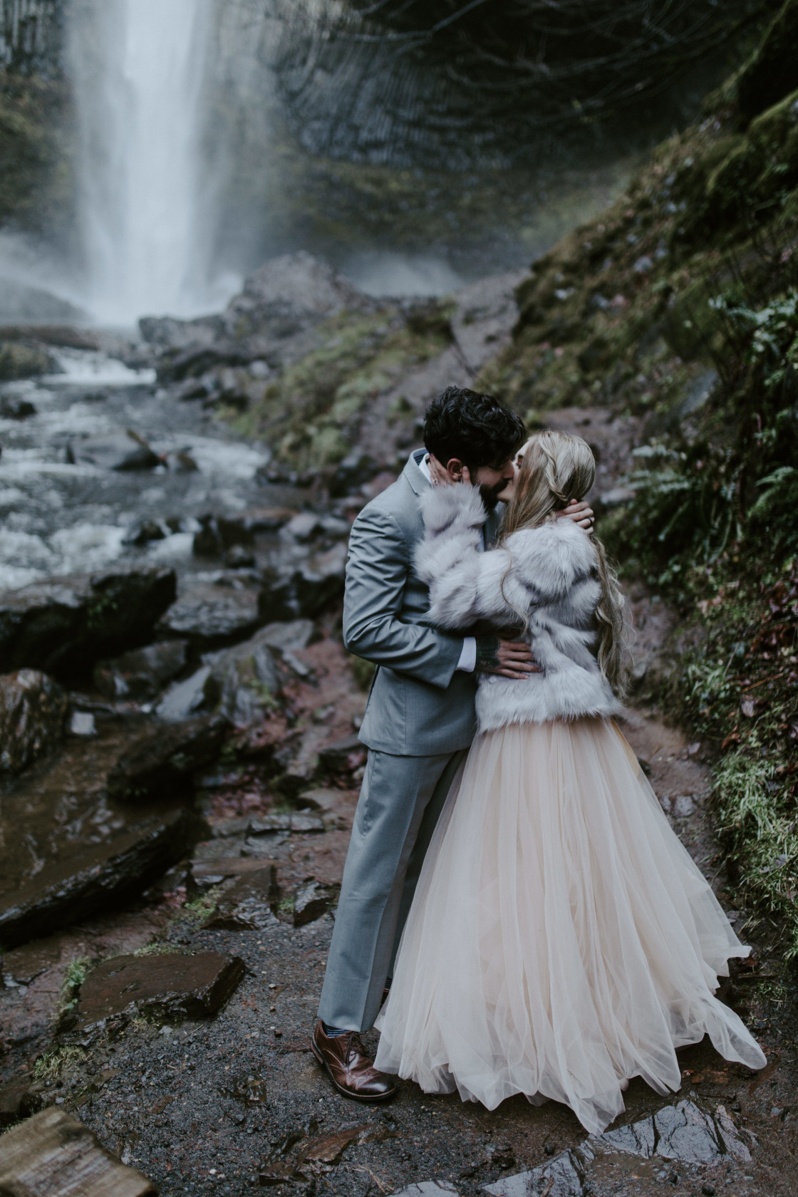Tyanna and Boris kiss in font of Latourell Falls, OR. Adventure elopement in the Columbia River Gorge by Sienna Plus Josh.