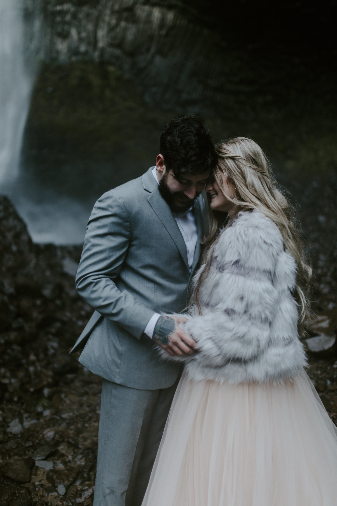 Tyanna and Boris stand in front of Latourell Falls, OR. Adventure elopement in the Columbia River Gorge by Sienna Plus Josh.