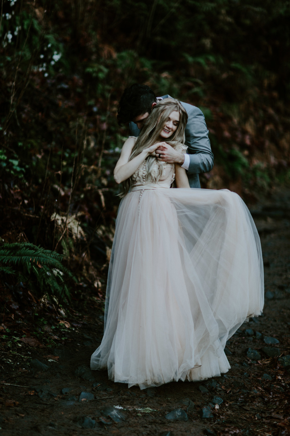 Boris holds Tyanna along a trail. Adventure elopement in the Columbia River Gorge by Sienna Plus Josh.