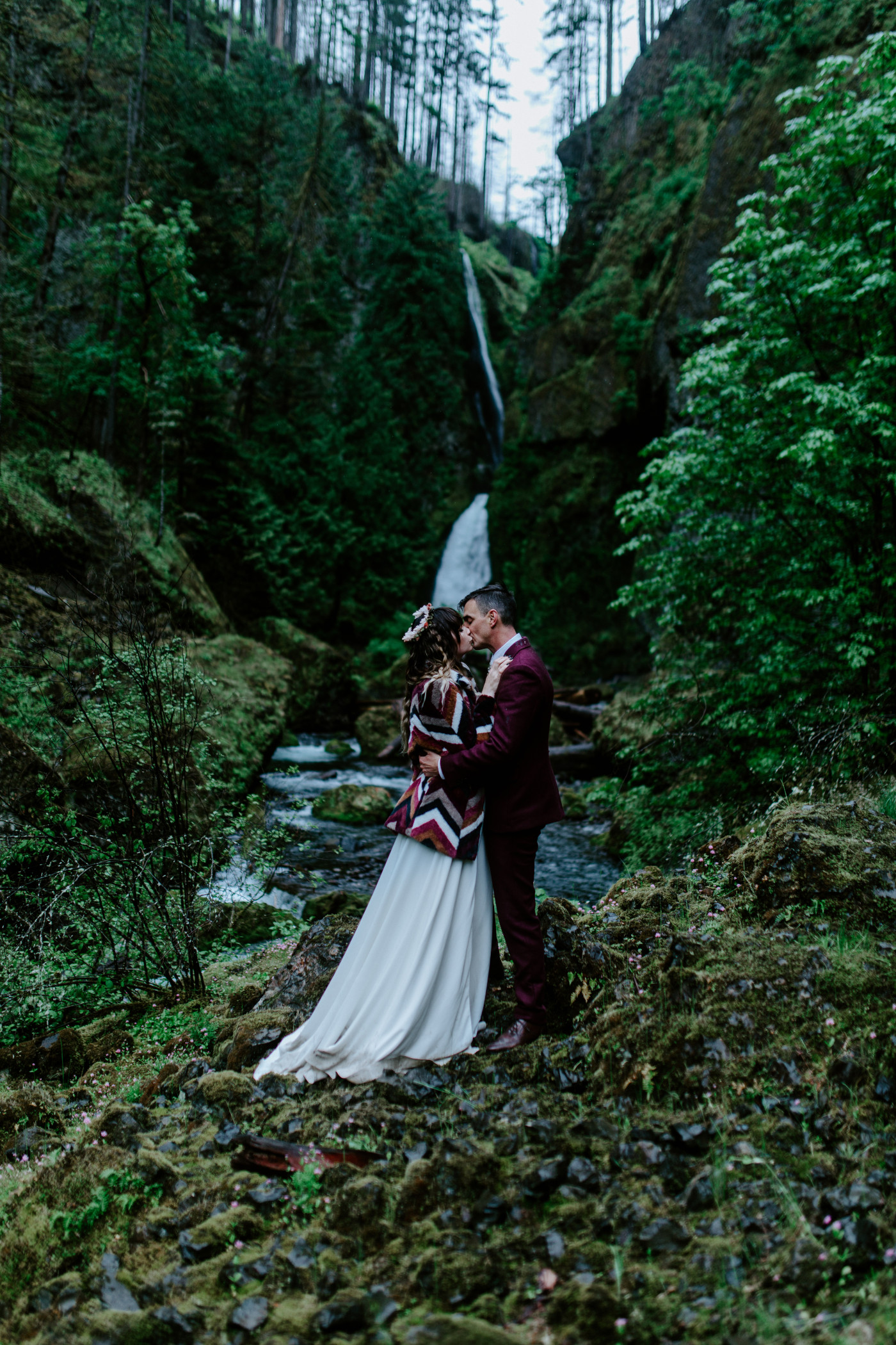 Andrew and Jordan kiss near the river in the Columbia River Gorge.