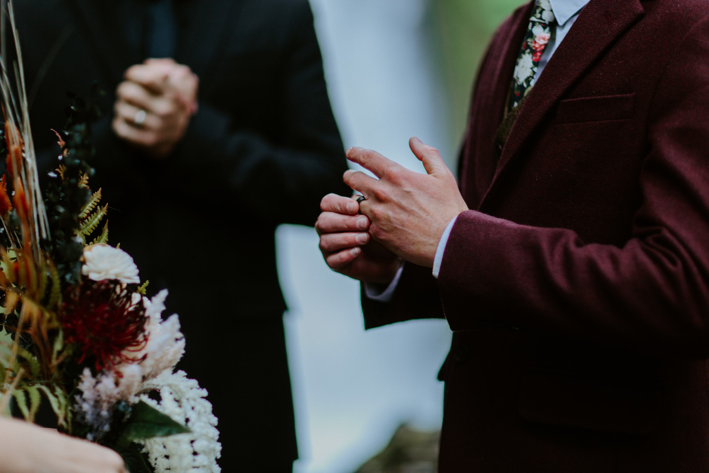 Andrew puts on his elopement wedding ring at Wahcella Falls.